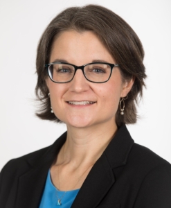 A portrait of a person smiling at the camera